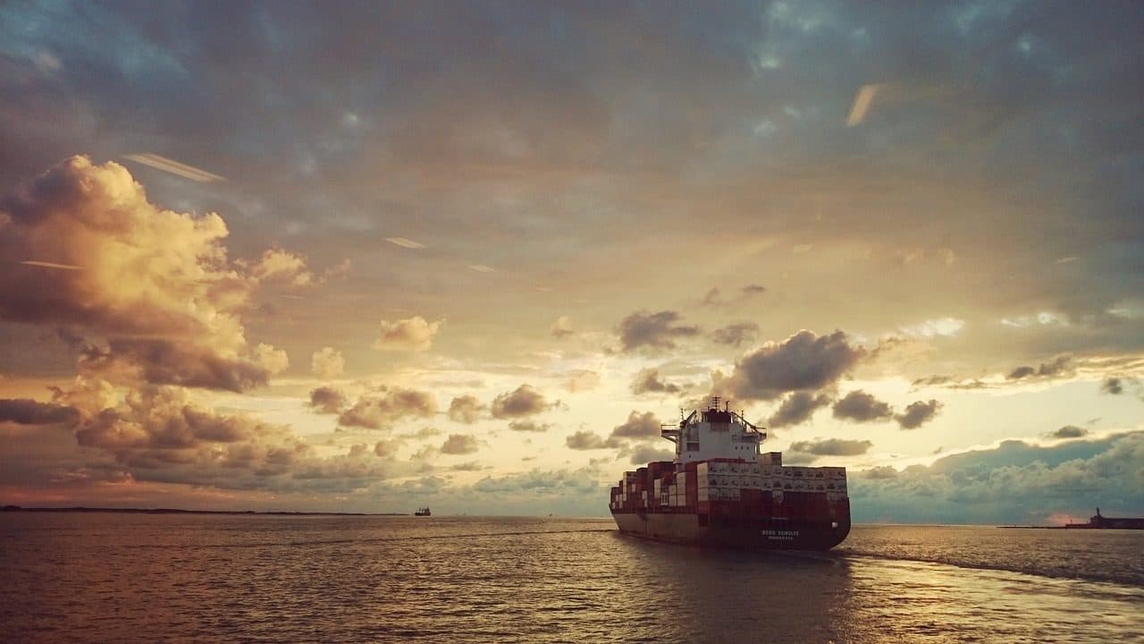 Container ship at sea at sunset